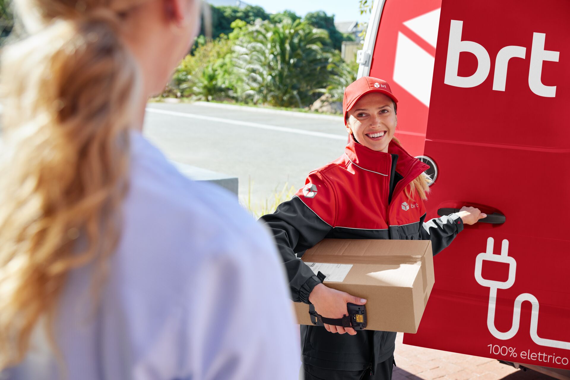 Driver at van holding a parcel